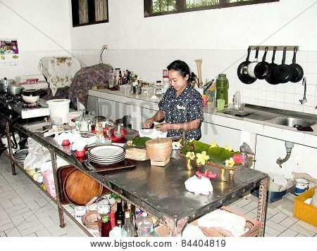 Woman Prepares In The Kitchen A Duck Balinese Style
