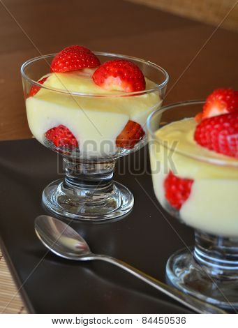 Dessert vanilla pudding with fresh strawberries