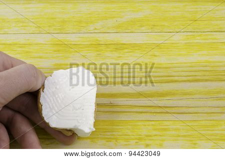 Holding A Freshly Cheese In Her Hand.