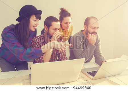 Young group of people/architects discussing business plans.
