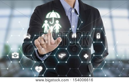 business salesman agent hand pressing button protection family concept travel insurance.