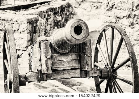 Close up photo of historic cannon. Retro object. Military theme. Black and white photo.