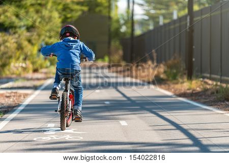 Australian boy riding his bicycle on bike lane on a day South Australia