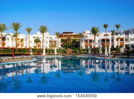 Sharm El Sheikh Egypt - August 25 2016: Swimming pool and palm trees at the resort in Sharm El Sheikh.