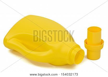 Yellow plastic bottle with a dispenser in cap isolated on white background. Detergent for ware and cleaning in kitchen.