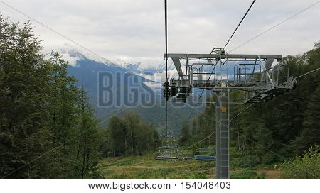 Ski lift on a background of snow-capped peaks