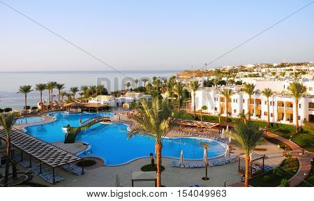 Sharm El Sheikh Egypt - August 22 2016: Swimming pool and palm trees at the resort in Sharm El Sheikh.