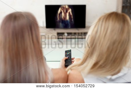 Women watching sexy man video in TV at living room