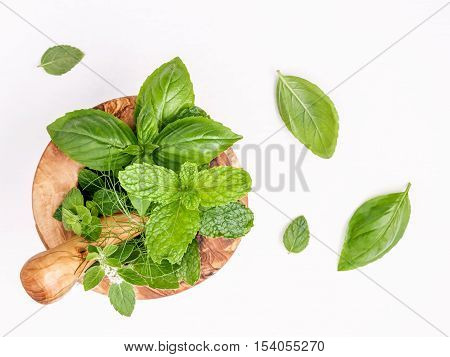 Alternative Medicine Fresh Herbs In The Wooden Mortar . Food Ingredients And Seasoning Basil, Pepper