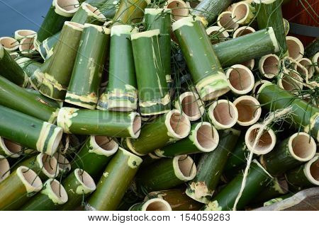 Pile of green bamboo tube hanging with rope