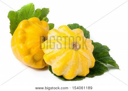 two yellow pattypan squash with leaf isolated on white background.