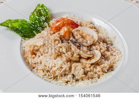 Risotto With Caramelized Spinach And Shrimps On A Plate
