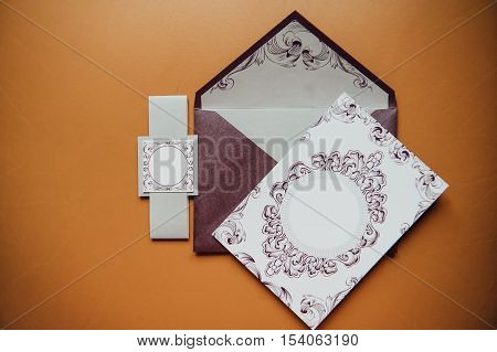 Stylish invitation card with envelope. on a orange background