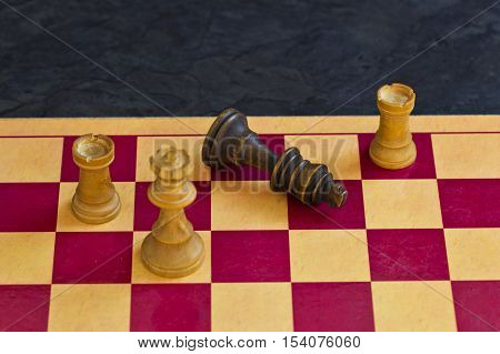 Black king falls over and resigns to show the game is over