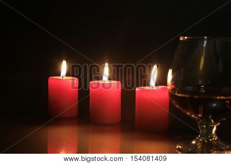 Christmas Photo Cognac Glass And Candle On Black Background