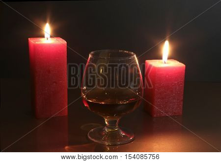 Christmas Photo Cognac Glass And Candle On Black Background