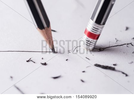 Write and erase Close up of a sharpened pencil writing a straight line