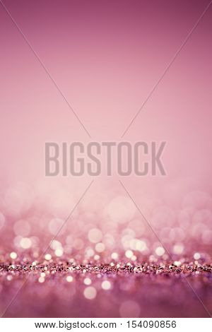 Abstract pink twinkled bright background with bokeh defocused lights.