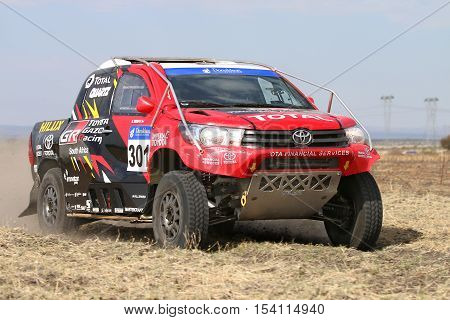 Close-up View Of Speeding Red And Black Toyota Hilux Twin Cab Rally Car
