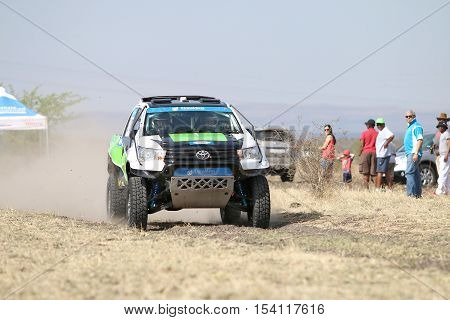 Speeding Green And White Toyota Hilux Twin Cab Rally Car Front View