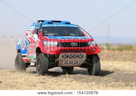 Close-up View Of Speeding Red And Blue Toyota Hilux Twin Cab Rally Car