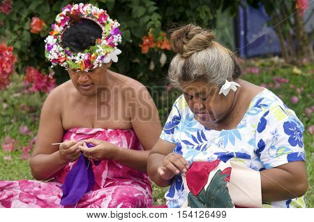 Portrait of Polynesian Pacific Island Tahitian mature females sewing Tivaivai outside their home in Aitutaki lagoon Cook Islands.