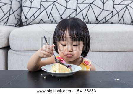 Moody Asian Chinese Little Girl Eating Birthday Cheese Cake