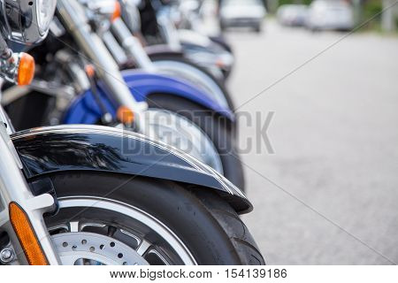 shallow depth of field on a row of motorcycles lined up on the street at the Lucan Baconfest