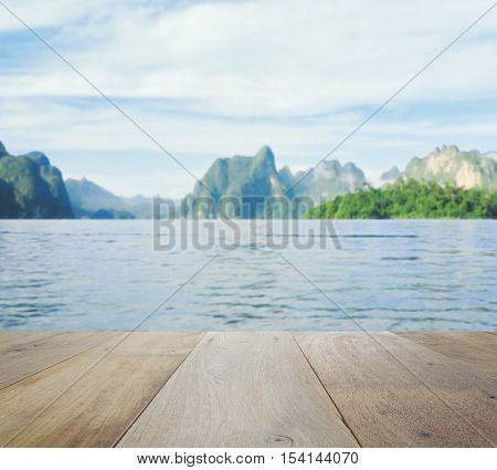Wood Table Top On Blurred Beautiful Landscape With Mountain And Lake