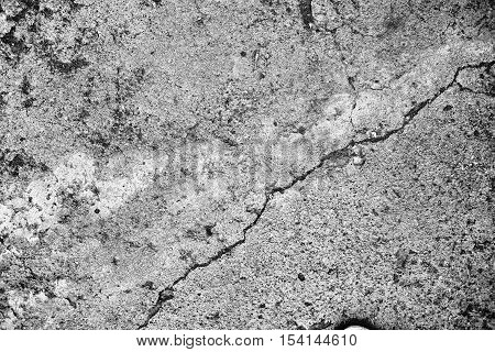 Crack in the rough concerete wall. Detailed photo
