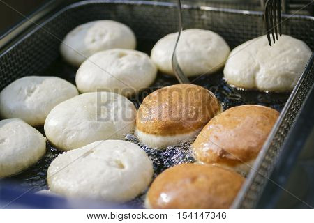 Preparation Of Donuts. Roasting In Boiling Oil