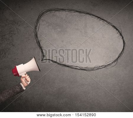 Caucasian business hand holding megaphone with drawn empty speech bubble
