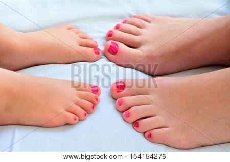 Mother And Child Paint Their Feet With Nail Polish