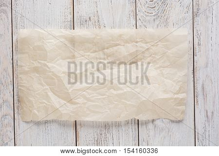 Cooking paper over wooden table background close up