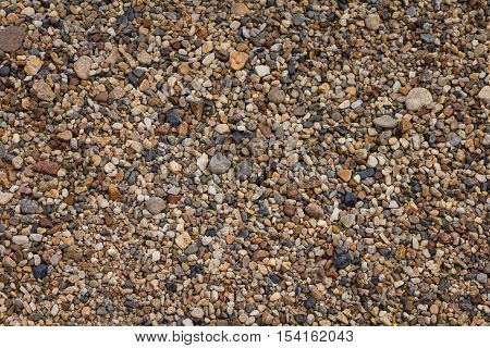 Small pebbles rock on the shore background
