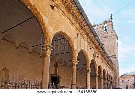The portico of Monreale Cathedral with the view on its medieval bell tower on the background Sicily Italy.