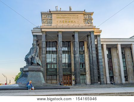 MOSCOW RUSSIA - MAY 10 2015: The facade of the Russian State Lenin Library and the monument to the famous writer - F Dostoevsky in front of it on May 10 in Moscow.