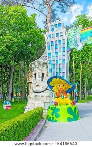 KHARKOV UKRAINE - MAY 20 2016: The entrance gate to the children's amusement park with the sculpture of Dunno (Neznayka) famous character of Nikolay Nosov's story Gorky Park on May 20 in Kharkov.