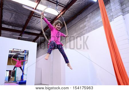 Little Child Learn Circus Skills On Aerial Lyra