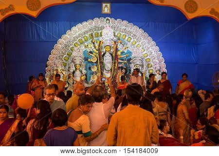 KOLKATA, INDIA - OCTOBER 9, 2016:Crowd gathered inside a Durga Puja pandal to offer prayer to Goddess Durga on Ashtami day at a Durga pandal in South Kolkata, West Bengal, India.
