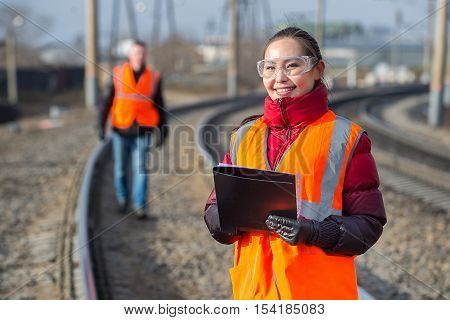 Man and a woman railroad workers maintaing railway