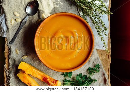 Pumpkin Porridge And Pumpkins On Black Wooden Table. Plate Pumpk