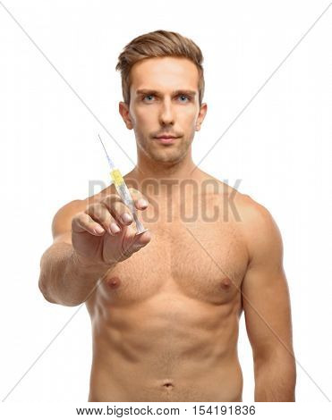 Muscular man holding syringe on white background