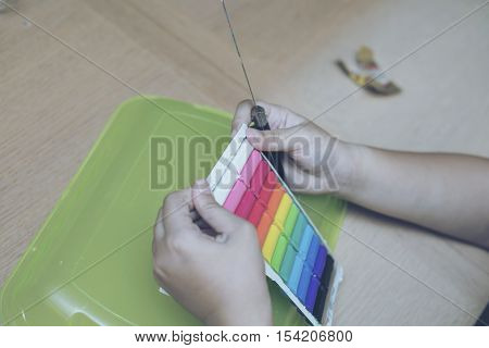 Children Playing Colorful Clay On Wood Table.