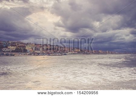 Beautiful landscape of the coast with dramatic sky and uncalm sea. Falconara Italy.