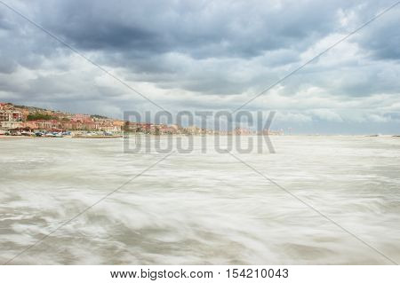 Beautiful landscape of the coast with dramatic sky and uncalm sea. Falconara Italy.