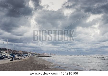 Beautiful landscape of the coast with dramatic sky and uncalm sea. Falconara Italy.