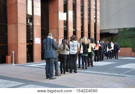 Sao Paulo Brazil - October 5: People standing in a line to enter office building on Avenida Paulista in the morning on October 5 2014 in Sao Paulo Brazil.