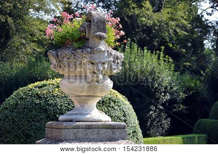 Historical Flowerpot With Human Head Statue In Castle Garden