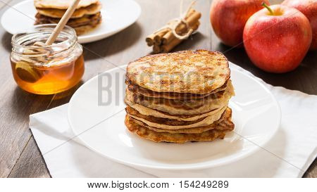 Apple cinnamon whole wheat pancakes on a white plate selective focus horizontal